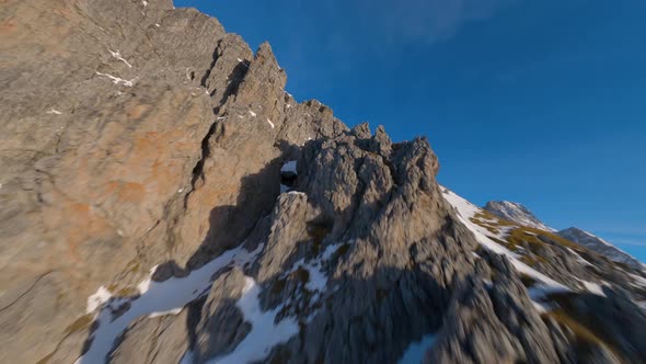 epic austrian winter mountain filmed by an fpv drone at sunrise