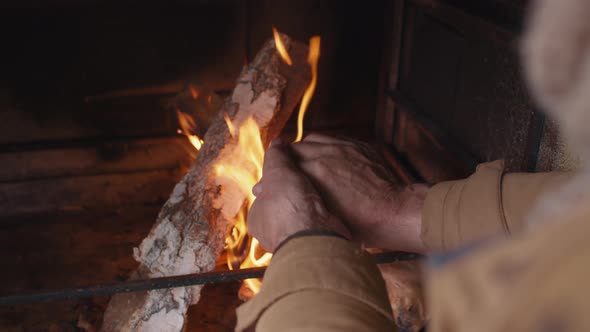 Unrecognizable Person Warming Hands by Fire