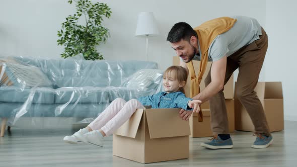 Loving Father Having Fun with Cute Little Daughter Relocating To New House Bonding with Kid