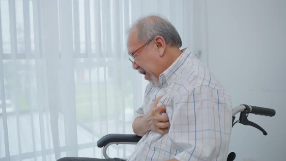Asian senior older man having chest pain feel suffer from heart attack.