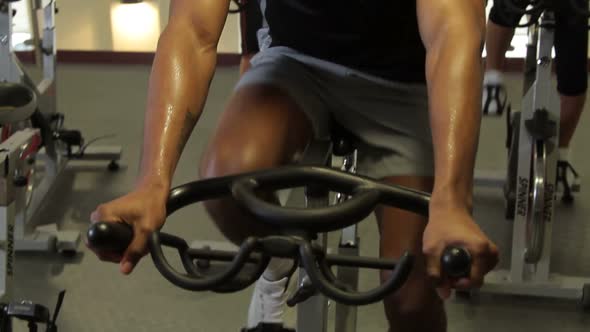 Group working out on bicycles in a gym