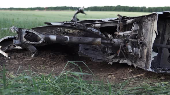 Downed military transport aircraft in a wheat field. Russian aggression in Ukraine.