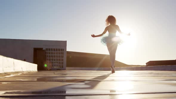 Ballet dancer practicing on rooftop