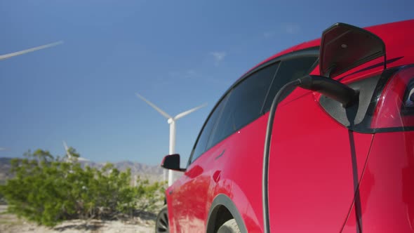 Slow Motion Closeup of Electric Car Charger on Sunny Summer Day Moving Windmills