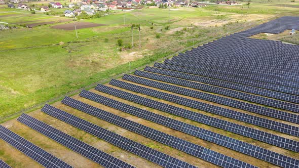 Aerial View of Big Sustainable Electric Power Plant with Many Rows of Solar Photovoltaic Panels for