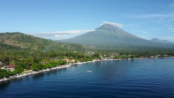 Fly Along Black Sand Beach with Volcano Mountains