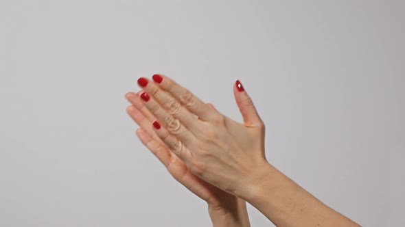 Woman Doing Claps Her Hands on a Gray Background