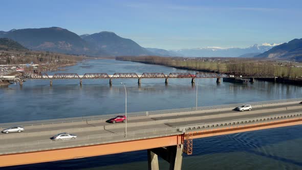 Cars Driving Across The Mission Bridge Next To Mission Railway Bridge Over Fraser River In BC, Canad