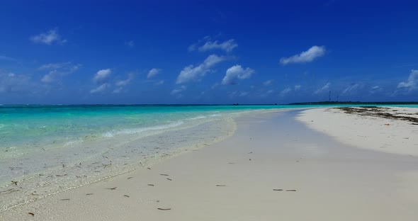 Wide birds eye abstract view of a paradise sunny white sand beach and aqua blue ocean background in 