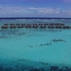 Aerial view of tropical island in Maldives. Overwater villas on turquoise water of Indian Ocean - VideoHive Item for Sale
