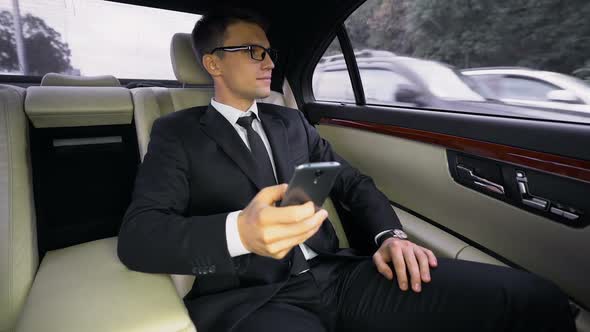 Successful Smiling Financial Expert Having Ride to Airport in Luxury Car, Trip