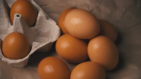 Woman's Hand Takes a Chicken Egg From a Container