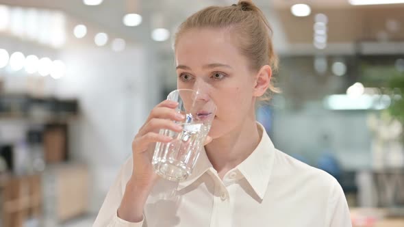 Portrait of Healthy Young Businesswoman Drinking Water 