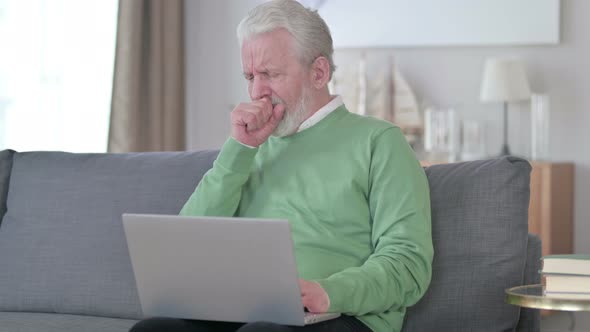 Sick Old Man with Laptop Coughing at Home