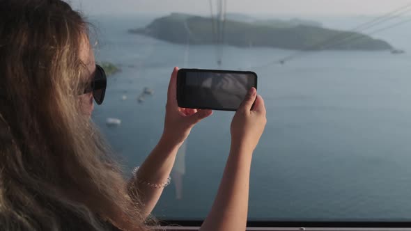 Woman Capturing Sea Scenery From Cable Car in Phu Quoc Vietnam