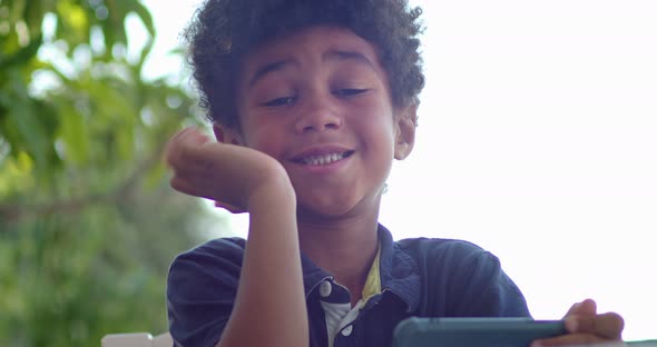 Closeup Portrait of a Child of an African Boy Who is Fooling Around Looking at the Camera Then