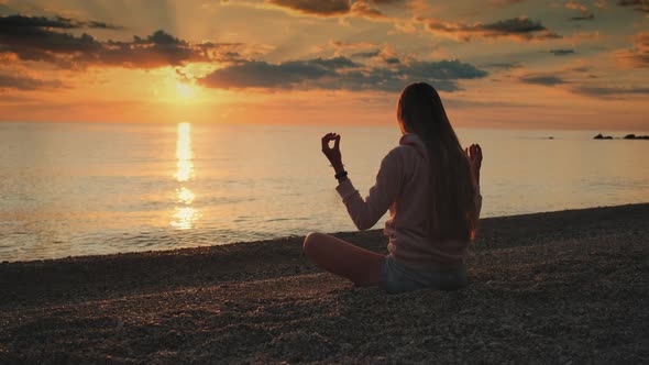 Lady Having Meditation Over the Sea Before Sunset