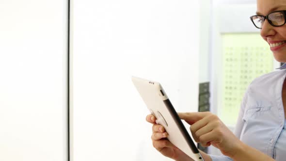 Customer using digital tablet in optical store