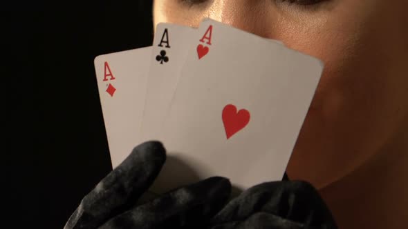 Beautiful Woman Hiding Behind Three of Aces Poker Combination, Victory Concept