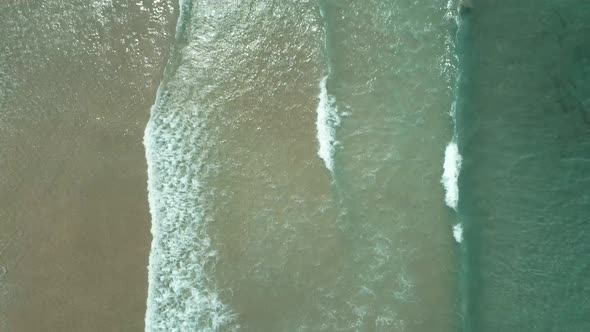 Top View of Waves Break on Tropical White Sand Beach