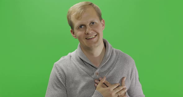 Handsome Young Man in Gray Sweater Doing Love Gesture. Chroma Key