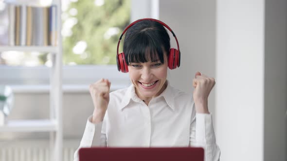 Portrait of Excited Young Caucasian CEO or Employee in Headphones Rejoicing Startup Success Making