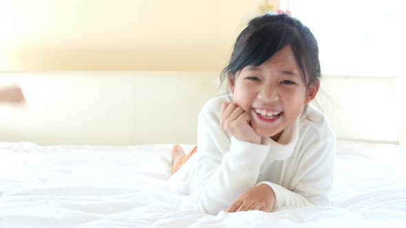 Cute Asian Children Playing On White Bed