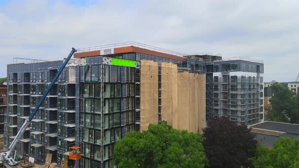Aerial view of the exterior of a building in construction, windows and balconies installed