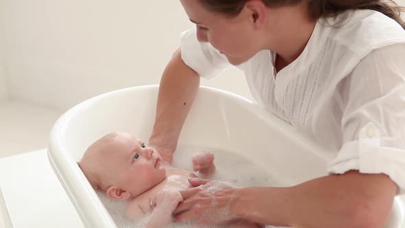 Mother bathing her baby
