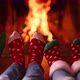 Happy family in Christmas socks near fireplace. Mother, father and children having fun together - VideoHive Item for Sale