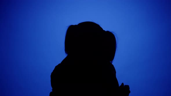 Two Women Hugging on Blue Neon Background