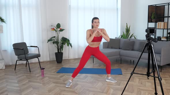 Fit Woman Fitness Trainer Blogger Doing Warmup Exercise Workout at Modern Home