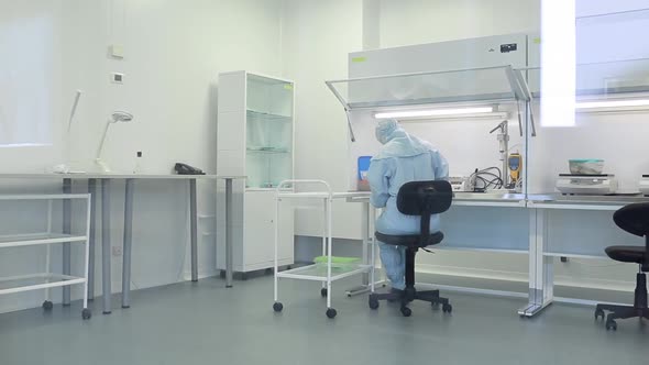 A Female Scientist Works in a Laboratory with Samples