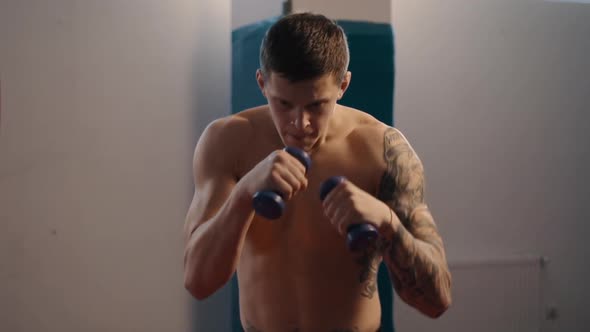 Young Boxer with Tattoos Does Shadow Fight