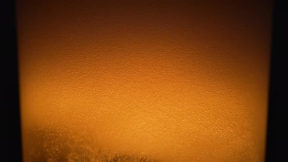 Extreme close-up beer in glass. Slow Motion. alt