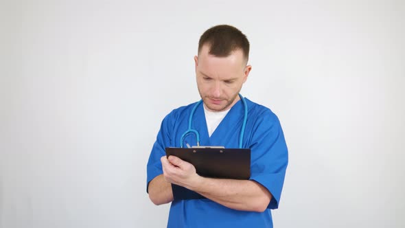 The doctor fills out documents on the tablet