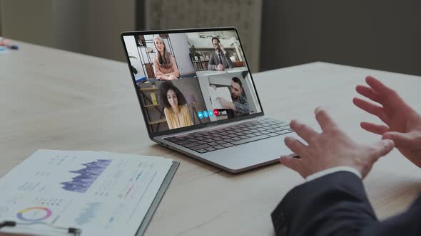 Rear View of Businessman Speak on Web Conference with Diverse Colleagues Using Laptop Webcam Male