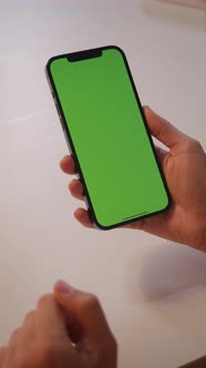 The Girl Touches the Green Screen of the Smartphone with Her Fingers