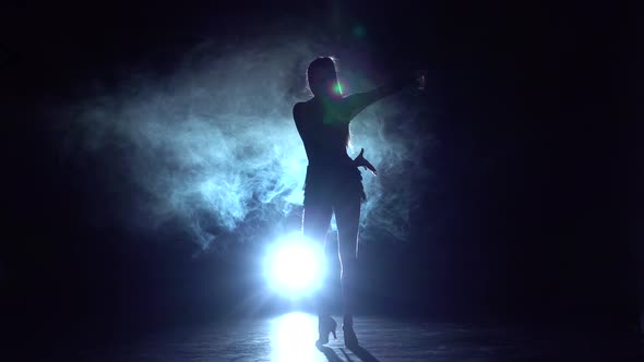 Dancer Performs Cha-cha-cha in the Studio, Silhouette. Slow Motion