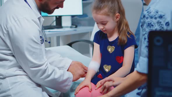 Little Girl Having Arm Bandaged