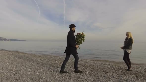 Woman Waiting at Sea Shore, Guy Presenting Her with Flowers, Couple Kissing