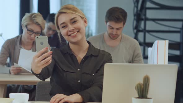 Young Businesswoman Making Selfie at Her Workplace