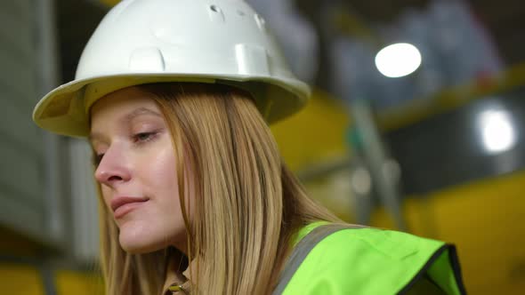 Closeup Face of Young Beautiful Woman in Hard Hat Standing on the Left Looking Away with Green Eyes