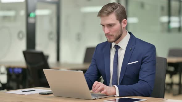 Businessman with Laptop Having Loss Failure