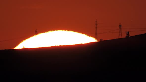 Sunrise Behind City's Electric Poles and Cables With Mega Telephoto Zoom Under Heat Radiation