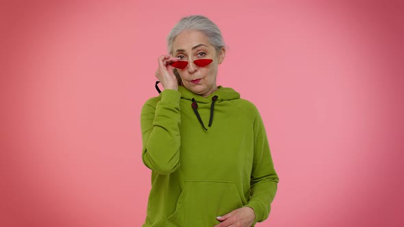 Happy Playful Stylish Senior Granny Woman in Sunglasses Blinking Eye Looking at Camera with Smile