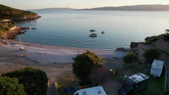 Aerial View of the Rocky Coast of Croatia with Camping and Curve Road at Sunset