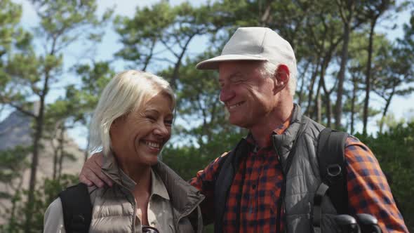 Front view of active senior couple in forest