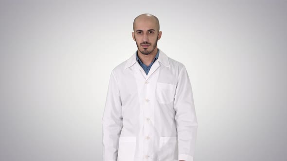 Walking Male Arab Doctor on Gradient Background.