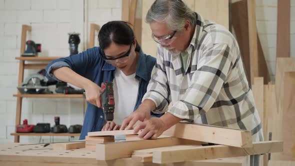 Carpenter use electric drill to drill wood